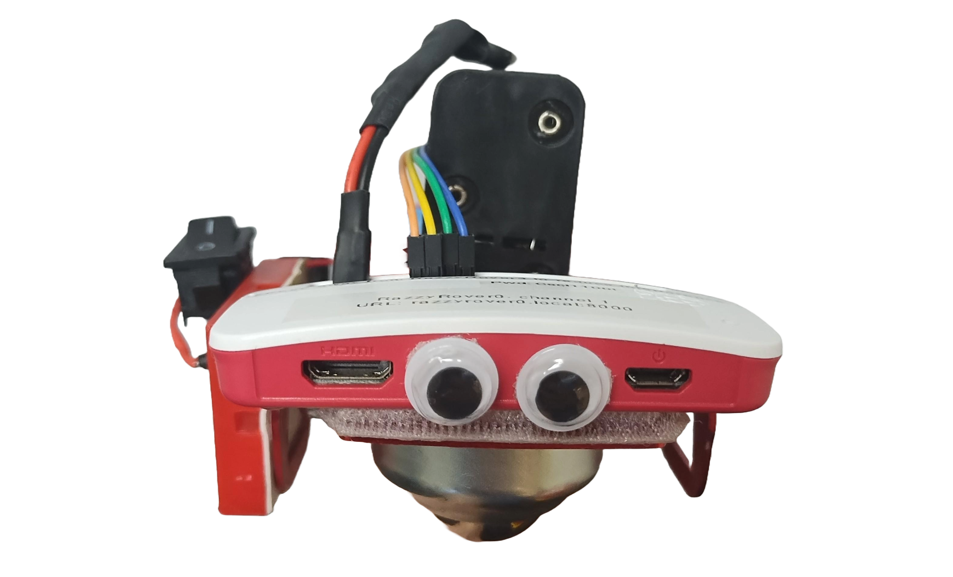 Wobbles the googly-eyed red robot with visible jumper wires and battery pack protruding from top